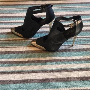 Black heels with gold embellishments.